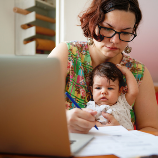 Photo of mum working from home with baby on lap